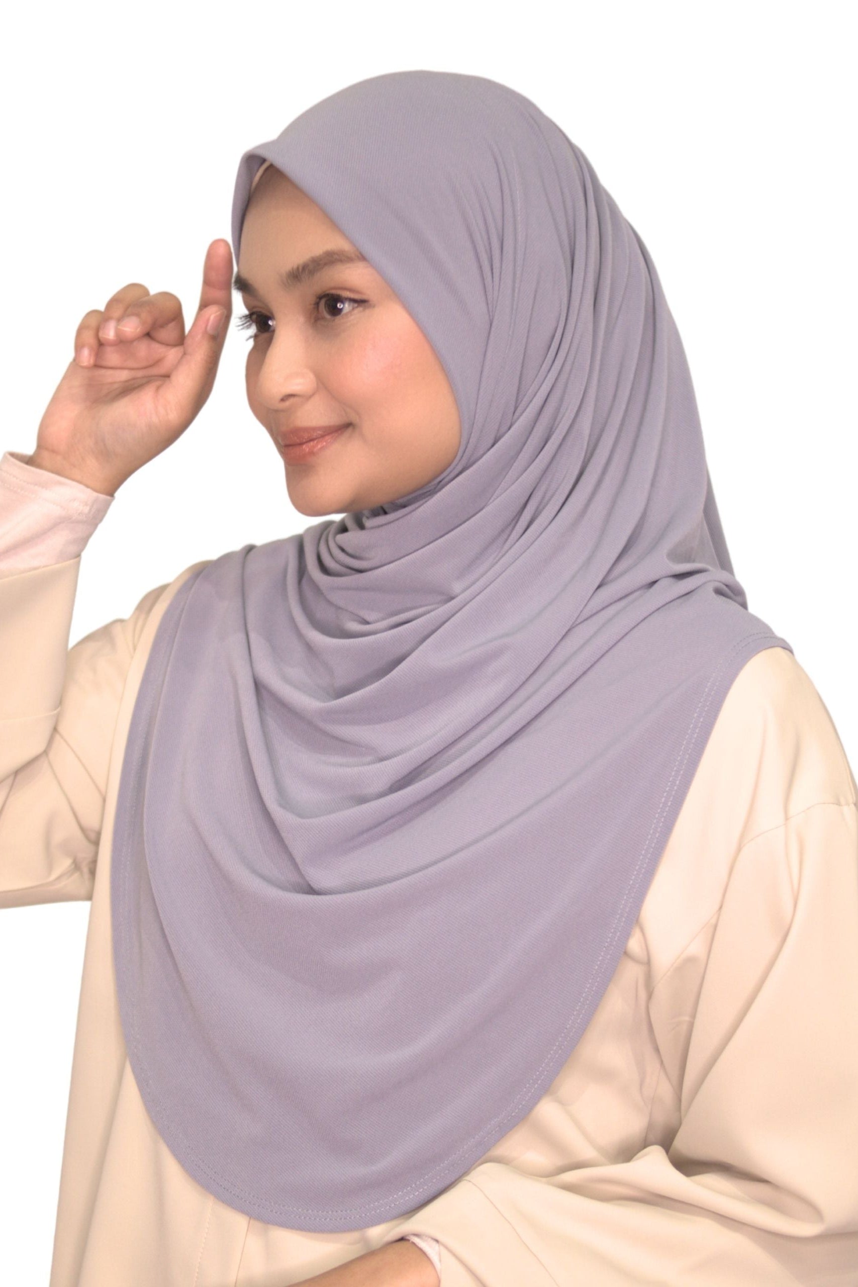 Woman wearing a light purple hijab on a white background