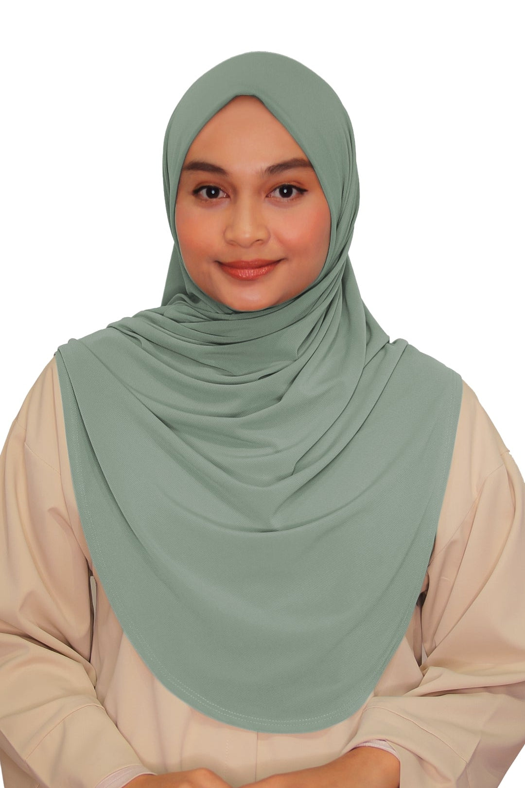 Woman wearing a light green hijab and beige outfit on a white background