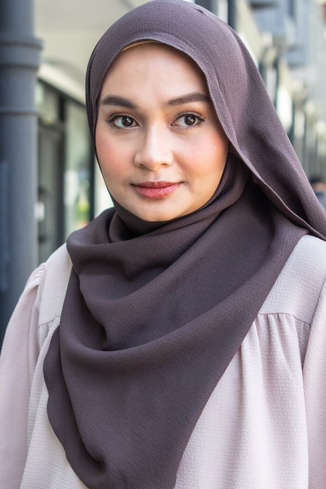 Woman wearing a dark hijab outdoors
