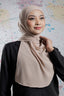 Woman wearing a beige hijab against a colorful abstract background