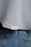 Close-up of a label on a garment with 'tashkila' branding.