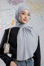 Woman wearing a gray hijab with a colorful abstract background