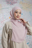 Woman wearing a light pink hijab and beige outfit against a colorful abstract background